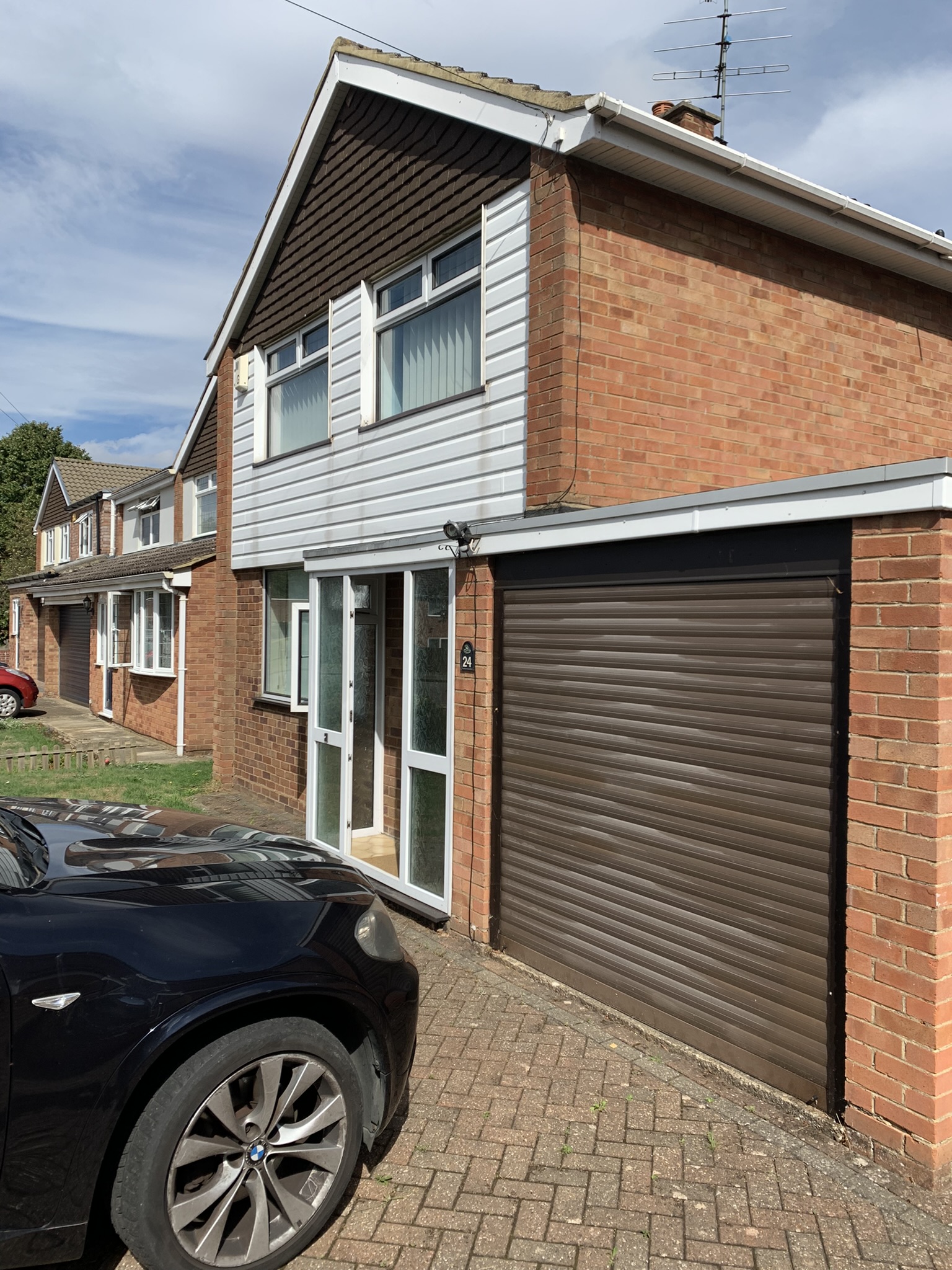 Closer view of the front of the house with the drive way and garage