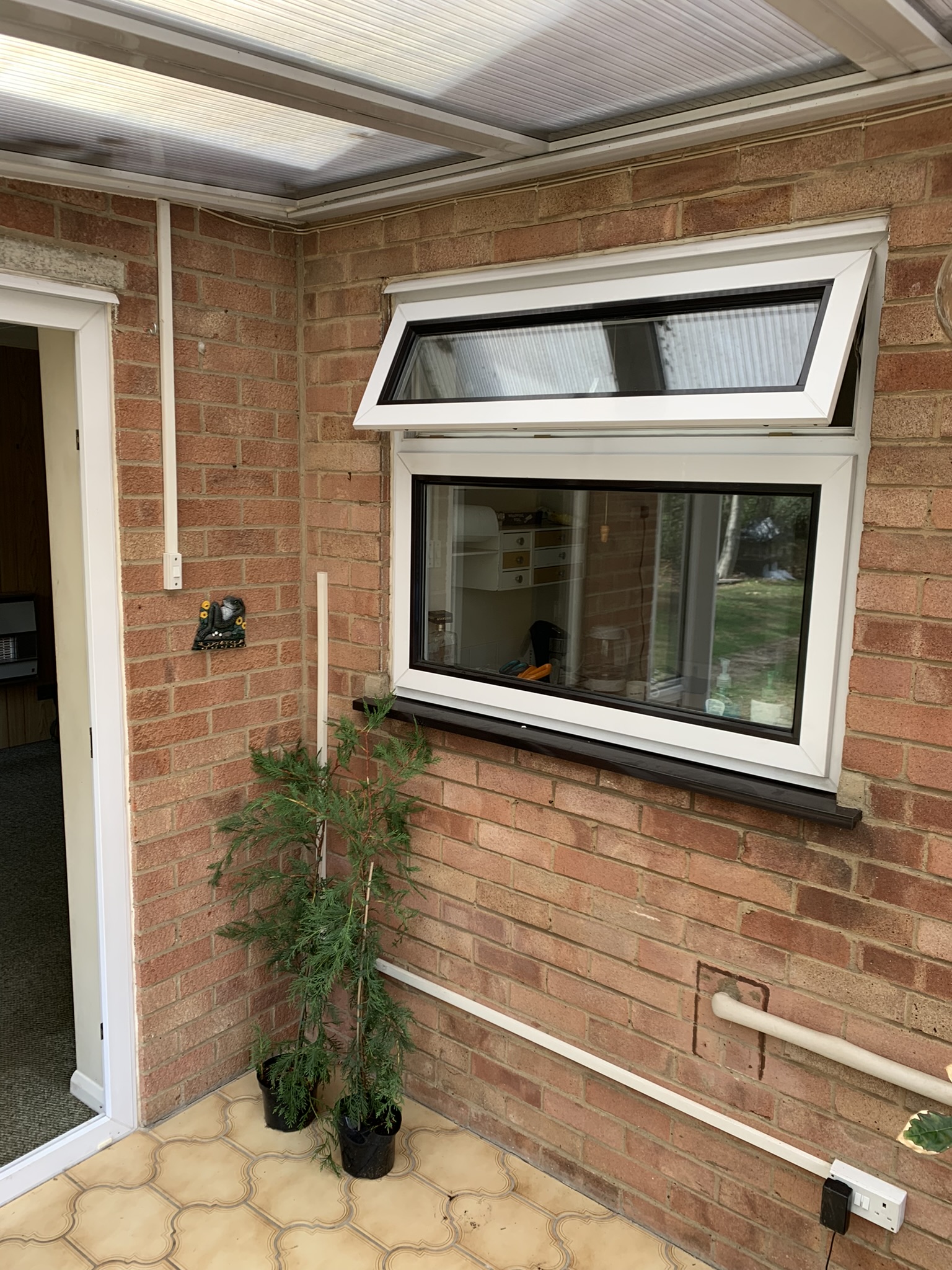 A picture of a kitchen window next to a front door