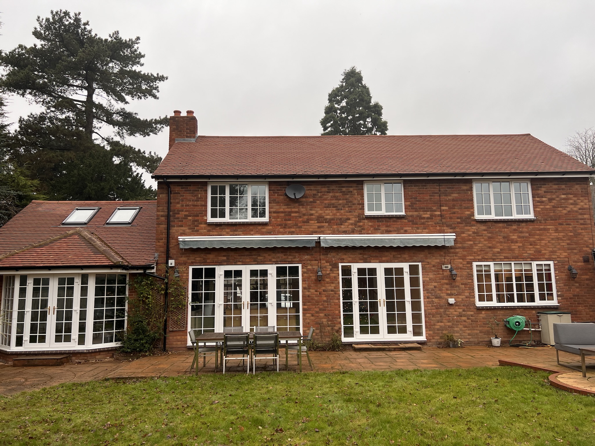 A central view of the rear extension with grass in the foreground