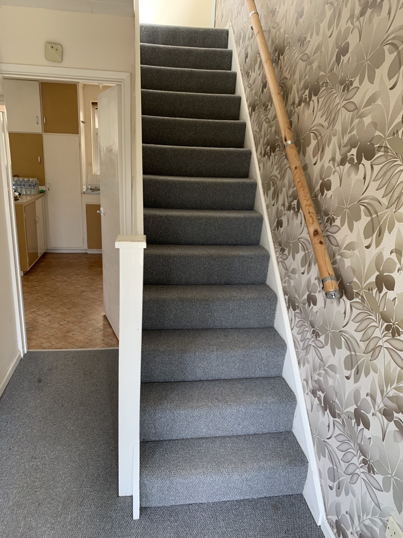 View of stairs and kitchen and stairs on the bottom floor